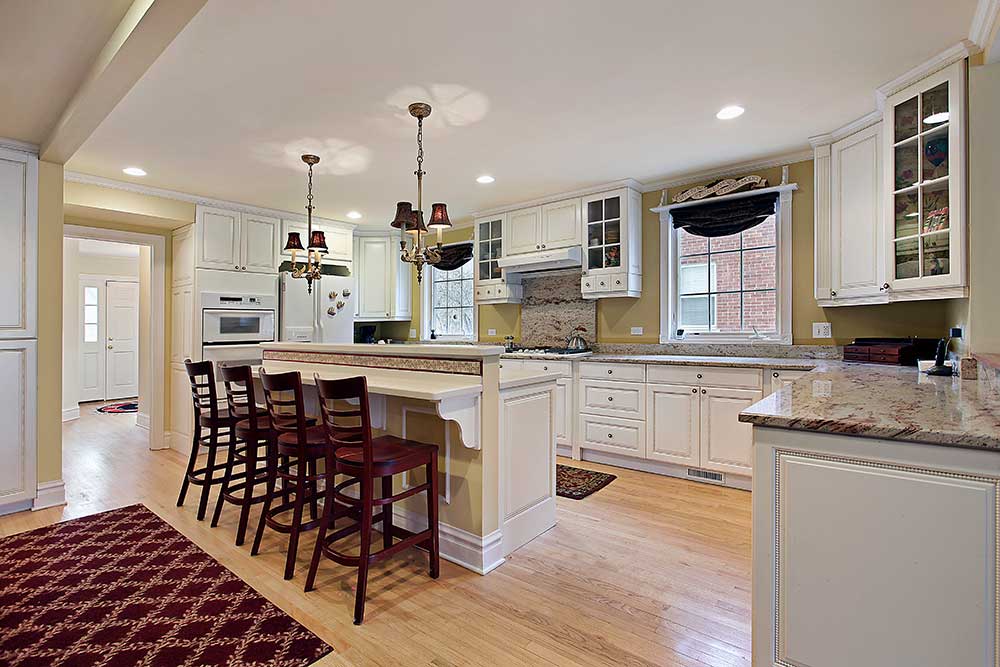 kitchen remodeling project with white cabinetry and granite countertops